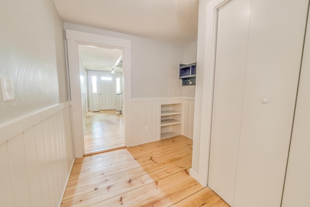 47 Main Rd N, Hampden, ME 04444 - corridor with light wood-type flooring, wainscoting, and a decorative wall