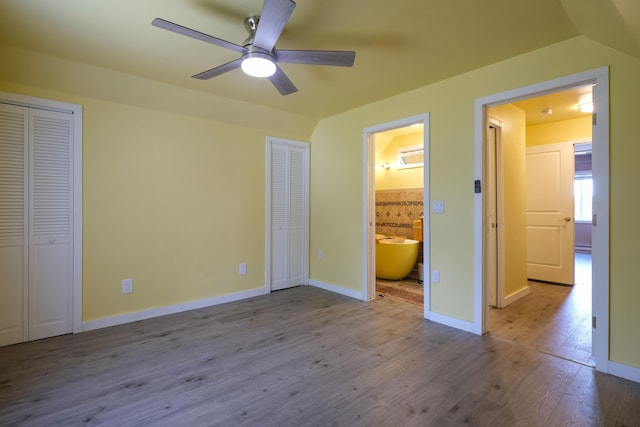 2 Church St, Deer Isle, ME 04627 - unfurnished bedroom with two closets, wood finished floors, ensuite bath, and a ceiling fan