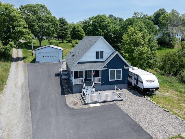 2 Church St, Deer Isle, ME 04627 - view of front of property with covered porch, an outbuilding, a detached garage, a shingled roof, and stairway