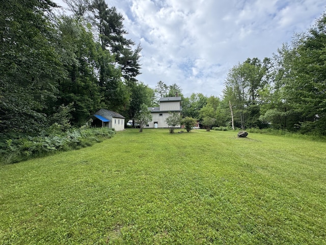 24 N Tiery St, Old Town, ME 04468 - view of green lawn featuring a storage unit