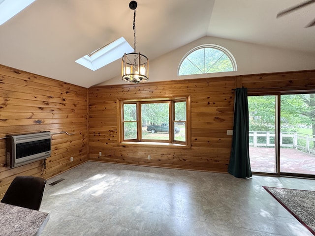 24 N Tiery St, Old Town, ME 04468 - unfurnished living room with a skylight, heating unit, lofted ceiling, wooden walls, and a chandelier