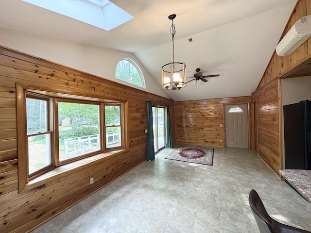 24 N Tiery St, Old Town, ME 04468 - foyer entrance with wood walls, lofted ceiling, a wall unit AC, a skylight, and a chandelier
