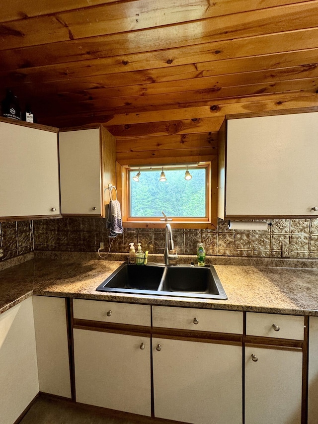 24 N Tiery St, Old Town, ME 04468 - kitchen featuring wood ceiling, white cabinets, and backsplash