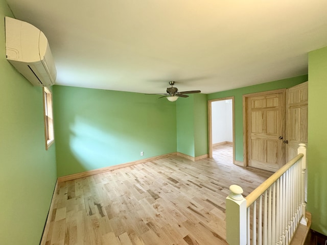 24 N Tiery St, Old Town, ME 04468 - empty room with light wood-type flooring, a wall mounted AC, and ceiling fan