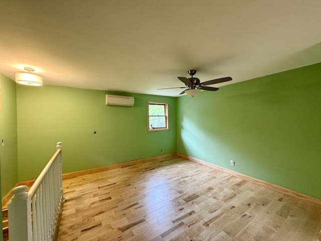 24 N Tiery St, Old Town, ME 04468 - spare room with a wall mounted air conditioner, ceiling fan, and light wood-style flooring