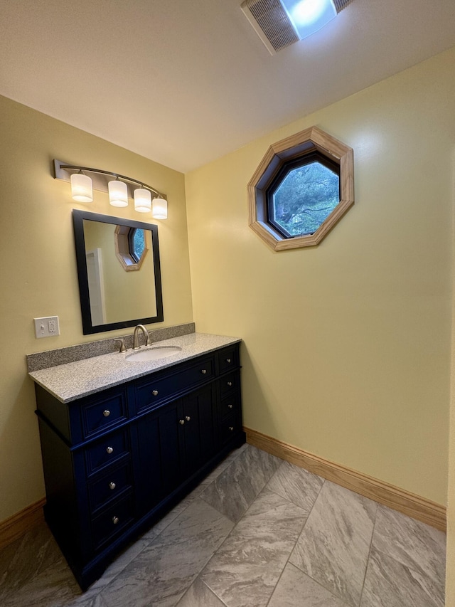 24 N Tiery St, Old Town, ME 04468 - bathroom featuring vanity and baseboards
