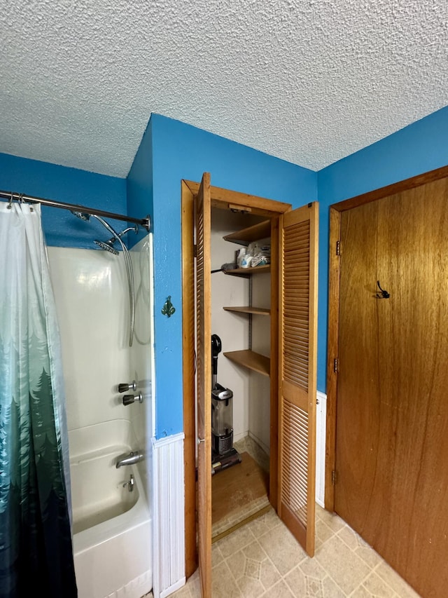 24 N Tiery St, Old Town, ME 04468 - bathroom featuring shower / bath combo, a closet, a wood stove, tile patterned floors, and a textured ceiling