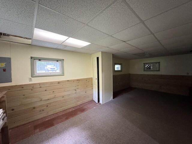 24 N Tiery St, Old Town, ME 04468 - basement with electric panel, carpet floors, a paneled ceiling, and wainscoting