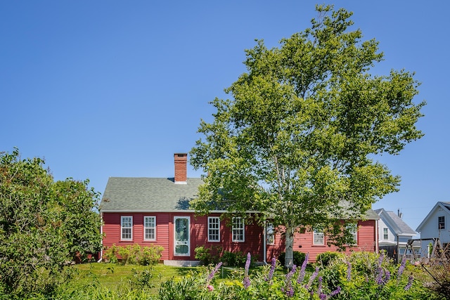5 Chestnut St, Vinalhaven, ME 04863 - view of front facade with a chimney, roof with shingles, and a front lawn