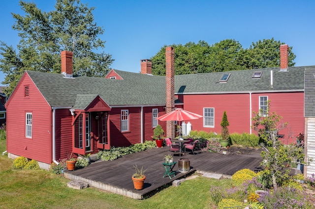 5 Chestnut St, Vinalhaven, ME 04863 - back of property with a deck, a chimney, a yard, and roof with shingles