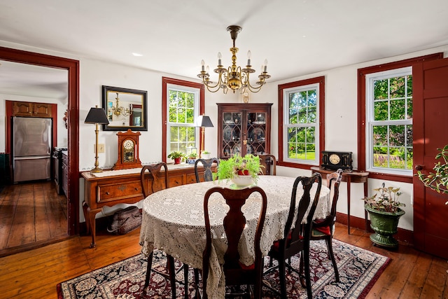 5 Chestnut St, Vinalhaven, ME 04863 - dining room featuring a chandelier and dark wood-style flooring