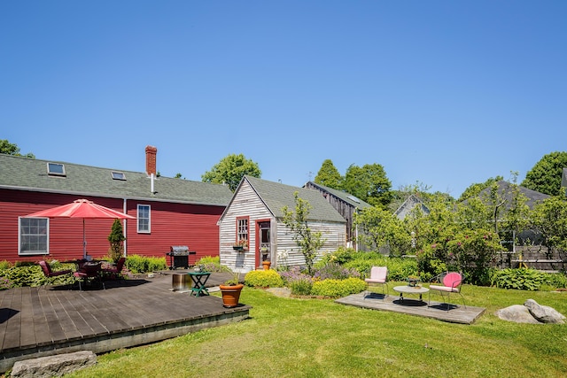5 Chestnut St, Vinalhaven, ME 04863 - back of house with a deck, an outbuilding, a chimney, outdoor dining area, and a shingled roof