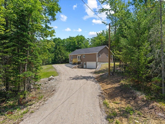 34 Oak Woods Dr, Hiram, ME 04041 - view of front facade with driveway, a garage, and a forest view