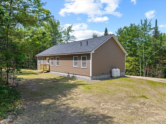 34 Oak Woods Dr, Hiram, ME 04041 - view of side of property with roof with shingles and a lawn