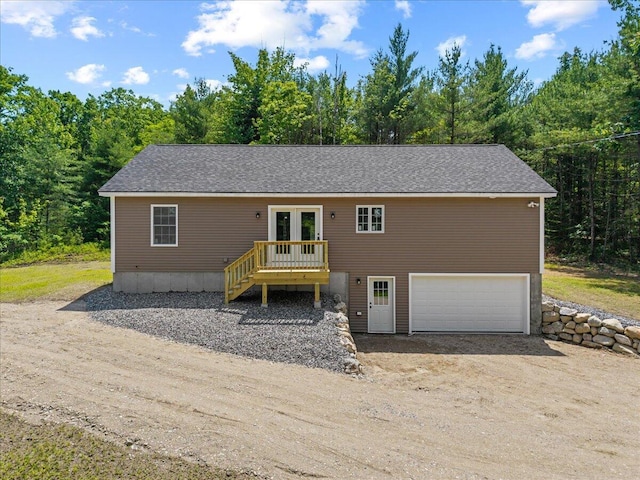 34 Oak Woods Dr, Hiram, ME 04041 - view of front facade with french doors, an attached garage, driveway, and roof with shingles