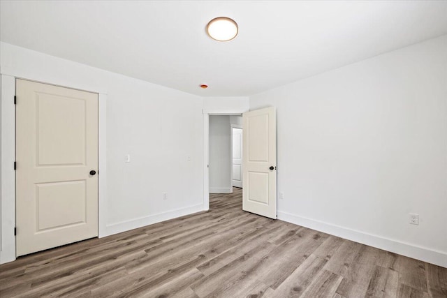 34 Oak Woods Dr, Hiram, ME 04041 - unfurnished bedroom with wood finished floors and baseboards