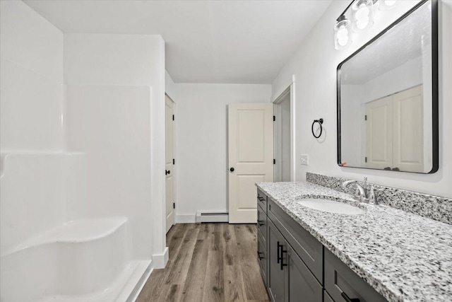 34 Oak Woods Dr, Hiram, ME 04041 - full bath with baseboard heating, vanity, and wood finished floors