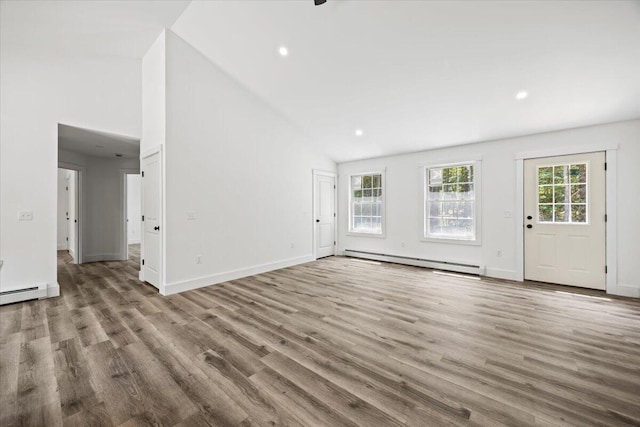 34 Oak Woods Dr, Hiram, ME 04041 - unfurnished living room with a baseboard heating unit, healthy amount of natural light, high vaulted ceiling, wood finished floors, and recessed lighting