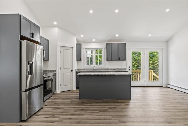 34 Oak Woods Dr, Hiram, ME 04041 - kitchen featuring stainless steel appliances, gray cabinetry, a baseboard radiator, a center island, and wood finished floors