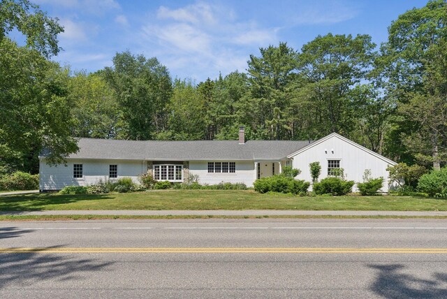 53 Beach Ave, Kennebunk, ME 04043 - view of front of home featuring a front lawn and a chimney