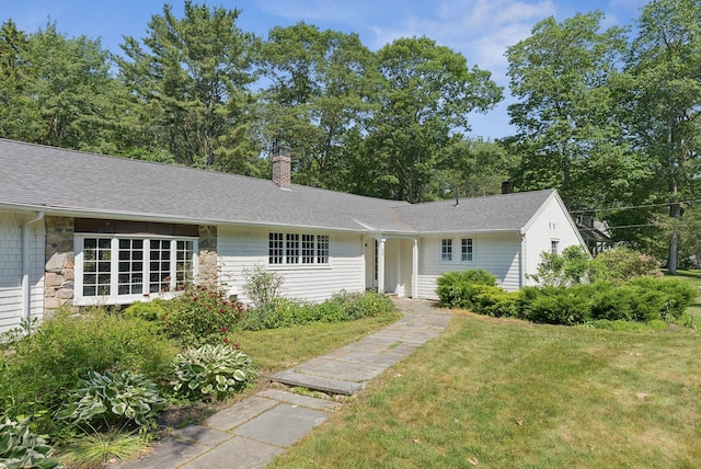 53 Beach Ave, Kennebunk, ME 04043 - ranch-style house featuring a chimney, a front yard, stone siding, and a shingled roof
