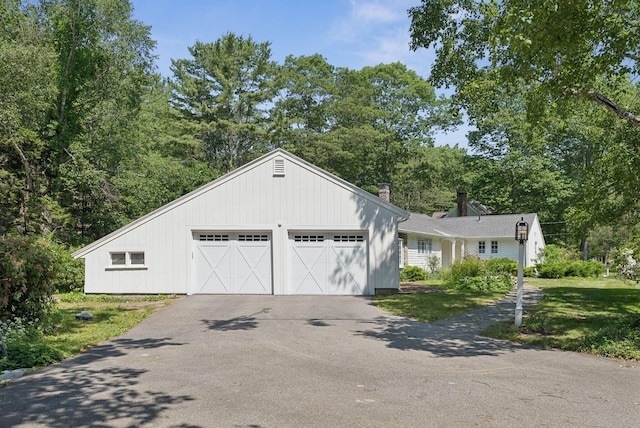 53 Beach Ave, Kennebunk, ME 04043 - view of front facade with a chimney and asphalt driveway