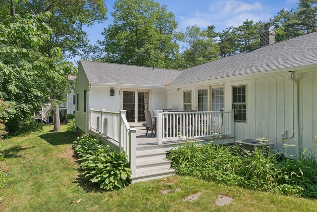 53 Beach Ave, Kennebunk, ME 04043 - view of front of house with a shingled roof, a wooden deck, a chimney, and a front lawn