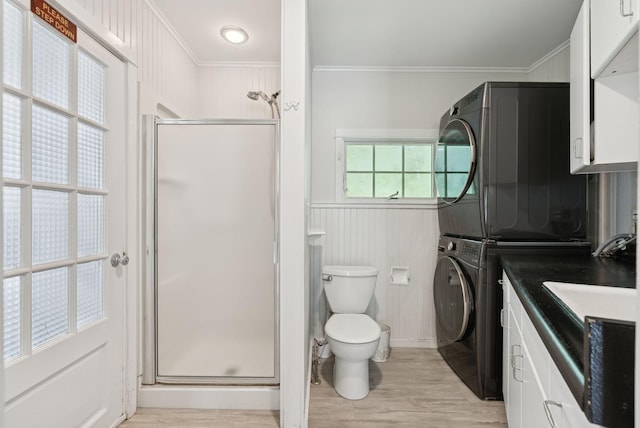 53 Beach Ave, Kennebunk, ME 04043 - full bath with estacked washer and dryer, ornamental molding, a stall shower, wood finished floors, and vanity