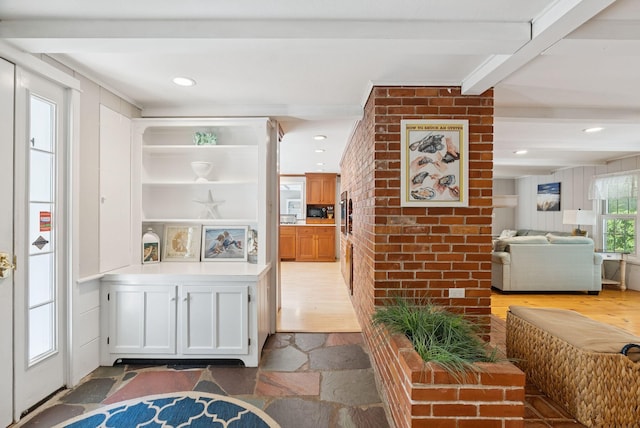 53 Beach Ave, Kennebunk, ME 04043 - kitchen with stone tile floors, open floor plan, light countertops, recessed lighting, and white cabinetry