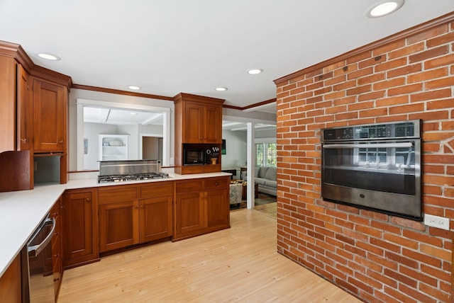 53 Beach Ave, Kennebunk, ME 04043 - kitchen with appliances with stainless steel finishes, light wood finished floors, light countertops, ornamental molding, and brown cabinets