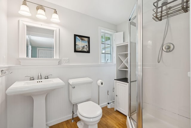 53 Beach Ave, Kennebunk, ME 04043 - bathroom with wood finished floors, a stall shower, and wainscoting
