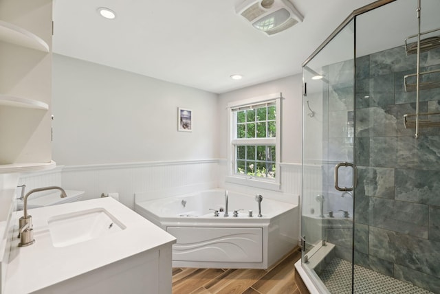 53 Beach Ave, Kennebunk, ME 04043 - full bath with a jetted tub, wood finished floors, a wainscoted wall, a shower stall, and vanity