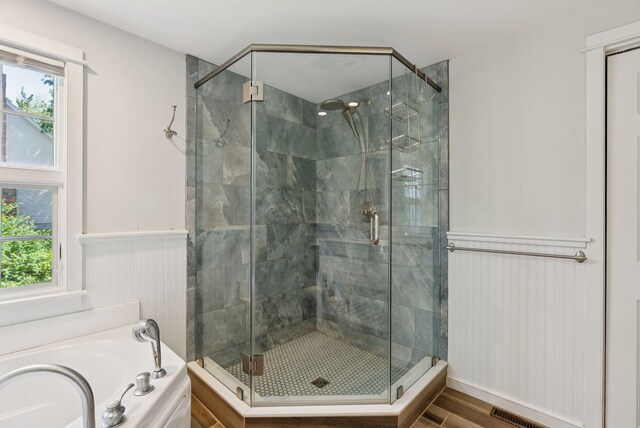 53 Beach Ave, Kennebunk, ME 04043 - bathroom featuring a shower stall, plenty of natural light, a bath, and a wainscoted wall