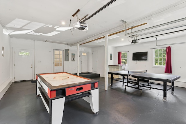53 Beach Ave, Kennebunk, ME 04043 - rec room with concrete flooring, electric panel, and a garage
