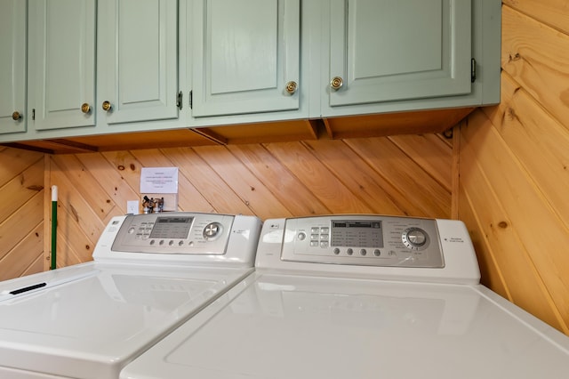 11 Overlook Rd, Rangeley, ME 04970 - laundry room featuring washing machine and clothes dryer, cabinet space, and wooden walls