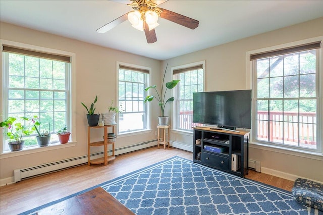 415 Waldoboro Rd, Jefferson, ME 04348 - living area featuring healthy amount of natural light, baseboard heating, wood finished floors, and a ceiling fan