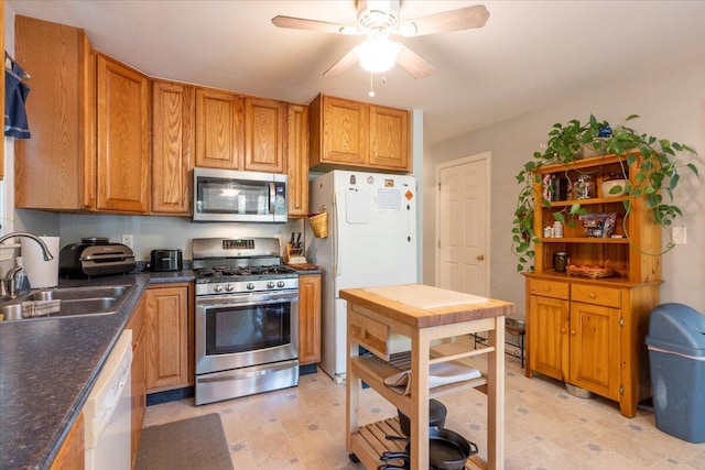 415 Waldoboro Rd, Jefferson, ME 04348 - kitchen featuring appliances with stainless steel finishes, ceiling fan, dark countertops, brown cabinets, and light flooring