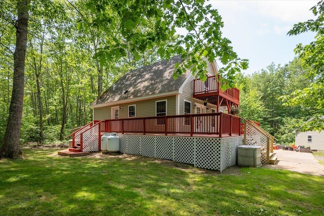 415 Waldoboro Rd, Jefferson, ME 04348 - back of property with a deck, a lawn, stairs, and roof with shingles