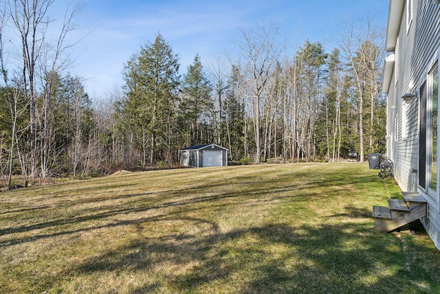 5 Harmony Way, Falmouth, ME 04105 - view of green lawn with a detached garage and an outdoor structure