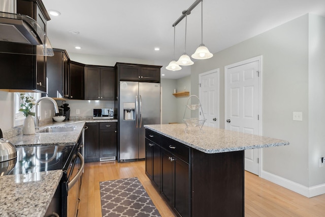 5 Harmony Way, Falmouth, ME 04105 - kitchen with appliances with stainless steel finishes, light wood-style floors, a kitchen island, decorative light fixtures, and light stone countertops