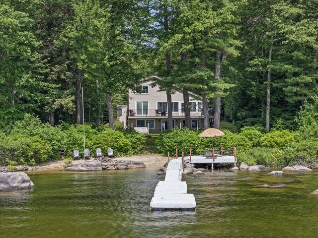 7 Papoose Island Rd, Raymond, ME 04071 - dock with a water view, a balcony, and a forest view