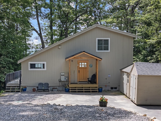 7 Papoose Island Rd, Raymond, ME 04071 - view of front facade with a wooden deck and a storage shed