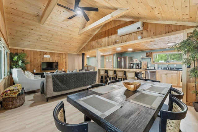 7 Papoose Island Rd, Raymond, ME 04071 - dining space with a wall mounted AC, wooden walls, wood ceiling, light wood-style flooring, and ceiling fan