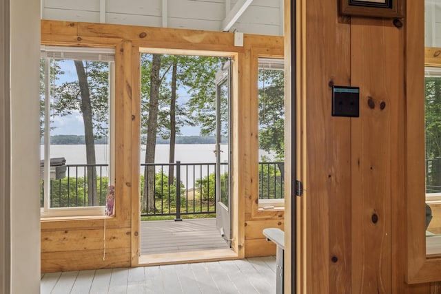 7 Papoose Island Rd, Raymond, ME 04071 - doorway with a water view, wood walls, and wood finished floors