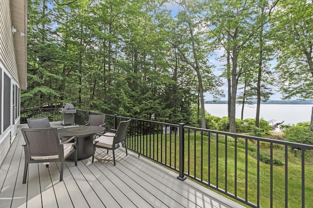 7 Papoose Island Rd, Raymond, ME 04071 - wooden deck featuring a water view, outdoor dining area, a grill, and a lawn