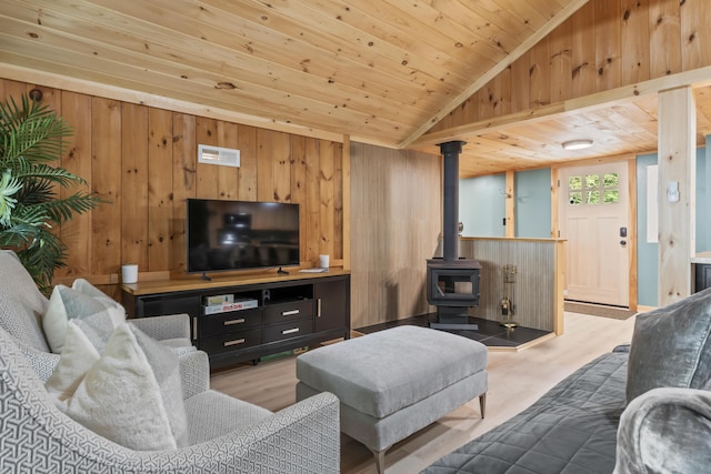 7 Papoose Island Rd, Raymond, ME 04071 - living area featuring a wood stove, wooden walls, wooden ceiling, wood finished floors, and vaulted ceiling