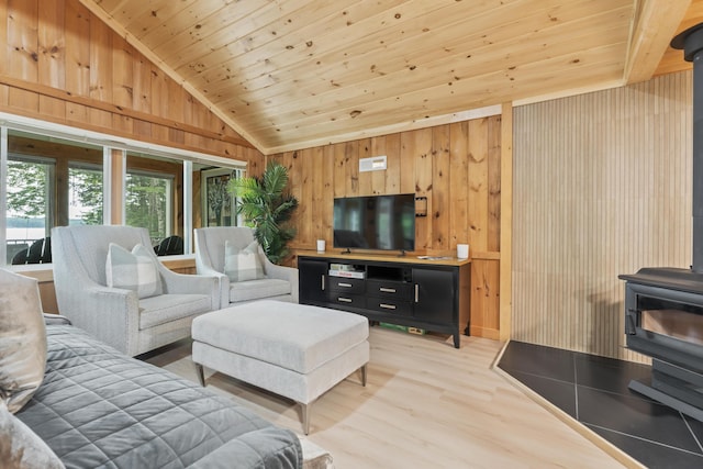 7 Papoose Island Rd, Raymond, ME 04071 - living room featuring a wood stove, vaulted ceiling, light wood-style floors, wood ceiling, and wooden walls