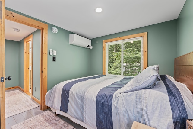 7 Papoose Island Rd, Raymond, ME 04071 - bedroom featuring a wall mounted AC and wood finished floors