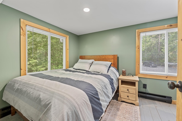 7 Papoose Island Rd, Raymond, ME 04071 - bedroom featuring a baseboard heating unit, wood-type flooring, and recessed lighting