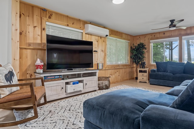 7 Papoose Island Rd, Raymond, ME 04071 - living area with a wall unit AC, wood walls, ceiling fan, and wood finished floors